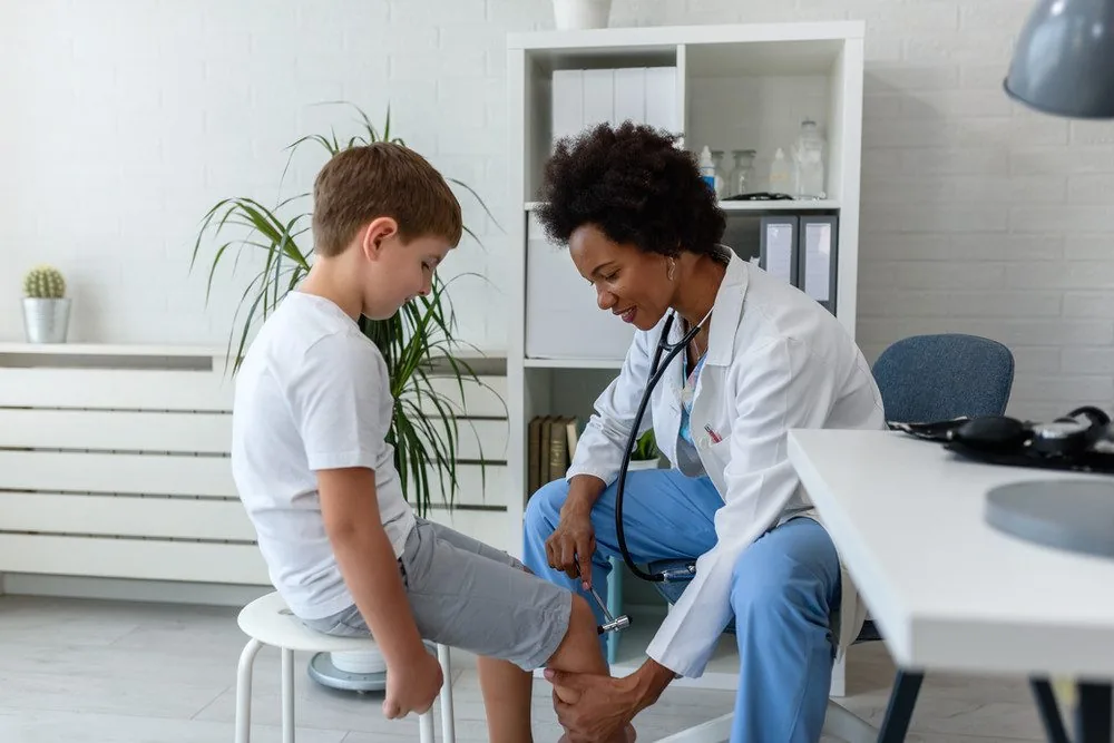 A clinician examining a patient's knee during a fitting.